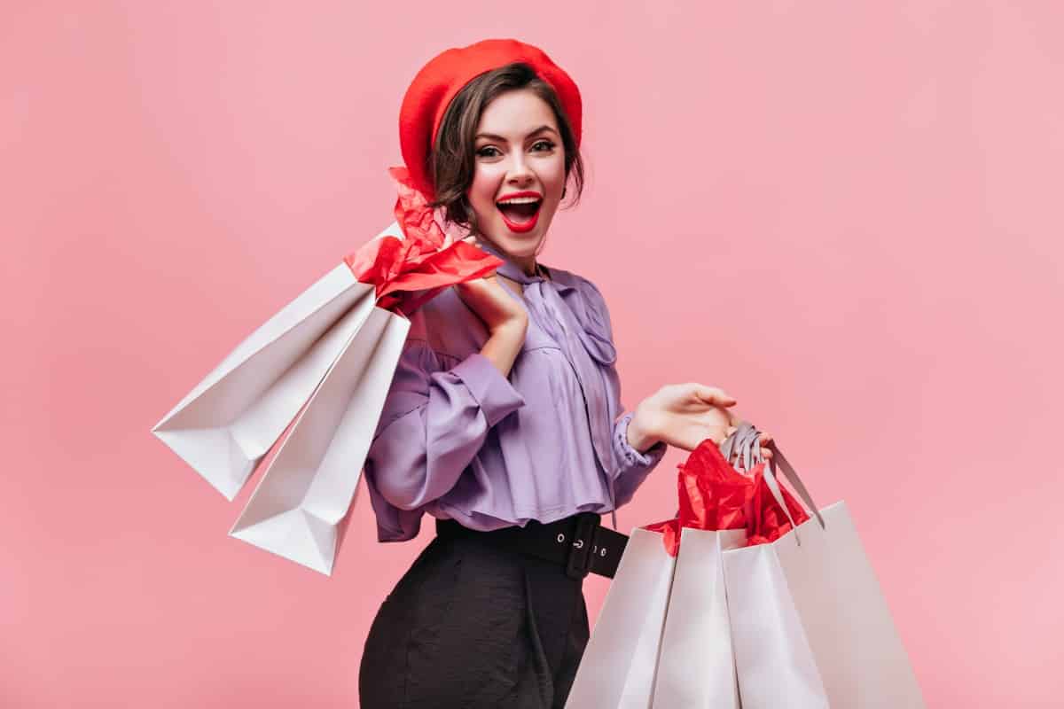 Woman Red Hat Black Trousers Light Blouse Laughs Poses With Packages After Shopping 1